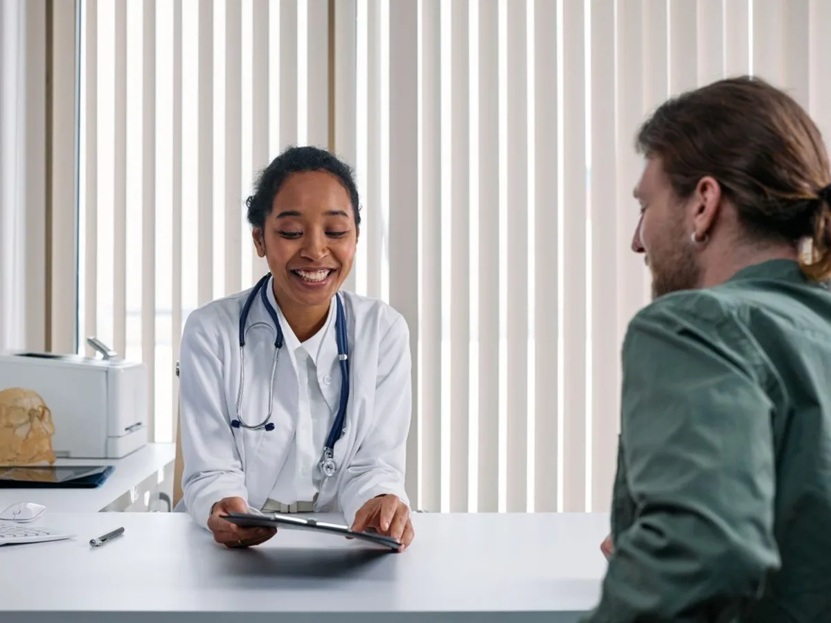 Clinician speaking with a patient during a routine office visit.